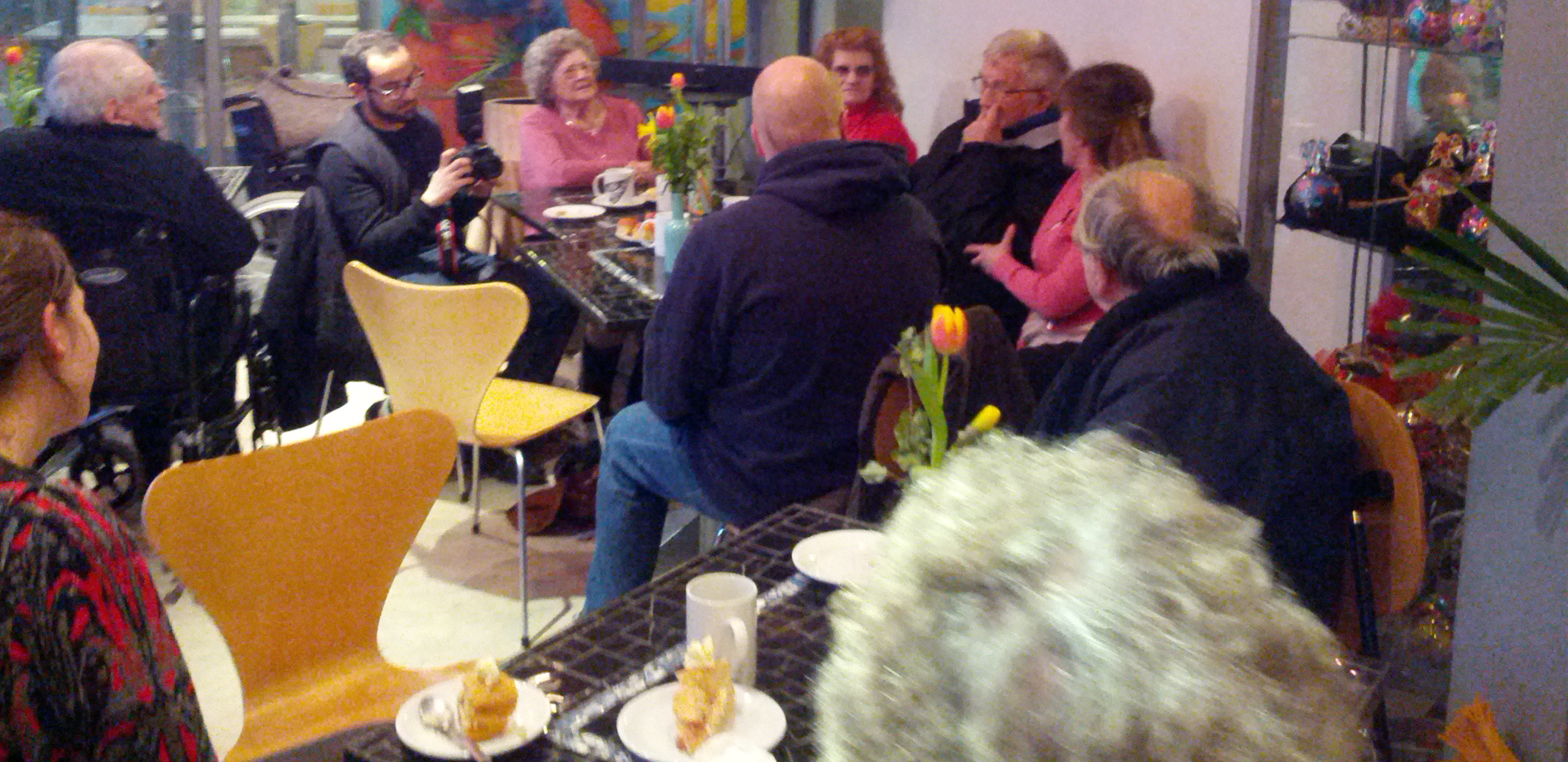 Participants discussing ideas during tea party workshop.
